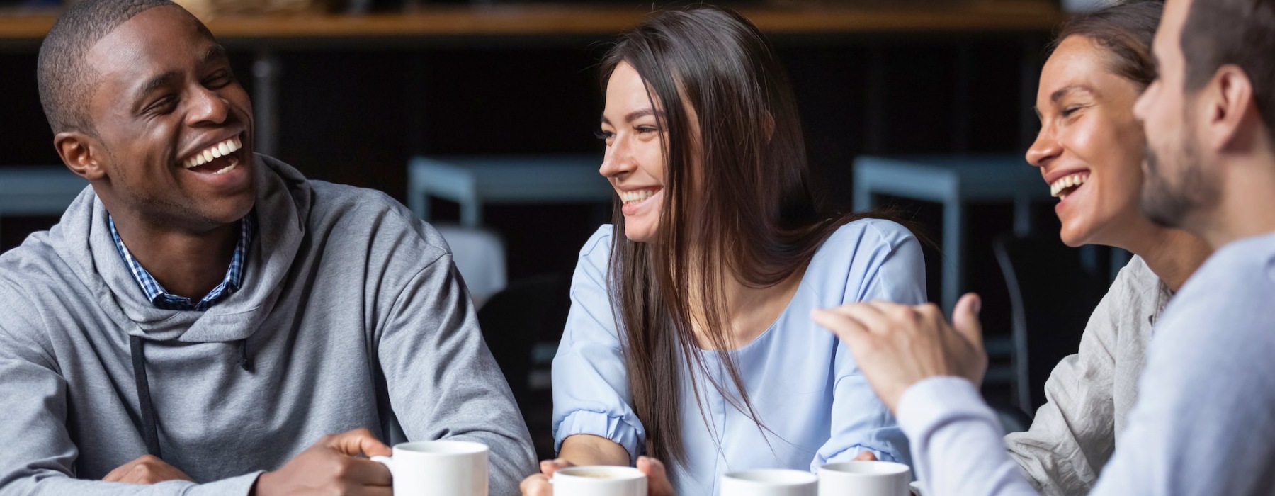 friends sitting together laughing