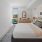 a bedroom with a bed and a chair
