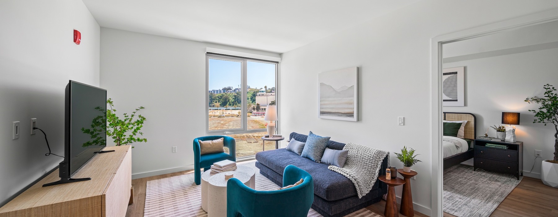 a living room with a tv and couches