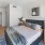 a bedroom with a bed and a desk